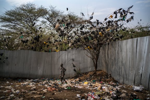 Szene aus dem Kakuma-Flüchtlingslager in Kenia: Ein Junge läuft durch einen Müllplatz, Januar 2017 © michael christopher brown